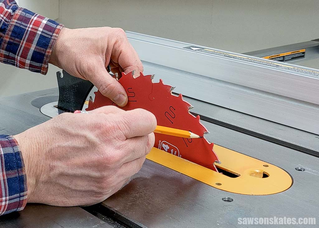 Pencil pointing at a table saw blade