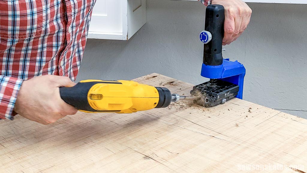 Using a pocket hole jig to drill pocket holes in the bottom of a DIY compressor cart