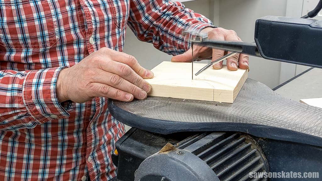 Using a scroll saw to cut out hose hanger for a DIY air compressor cart