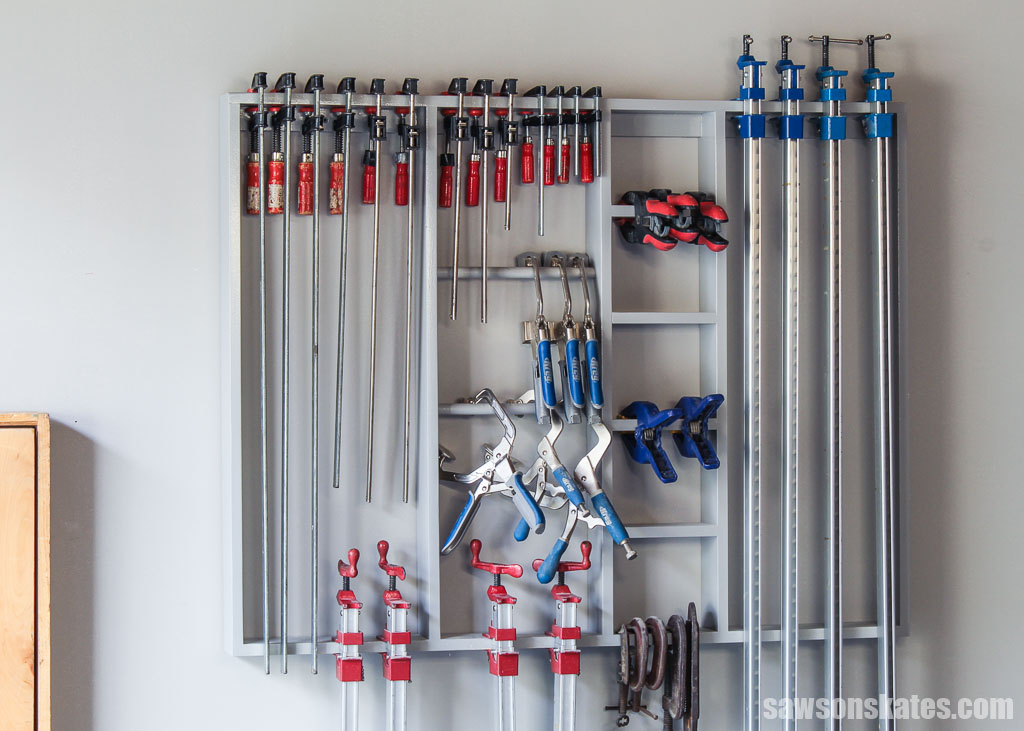 Front view of a wall-mounted DIY clamp storage rack