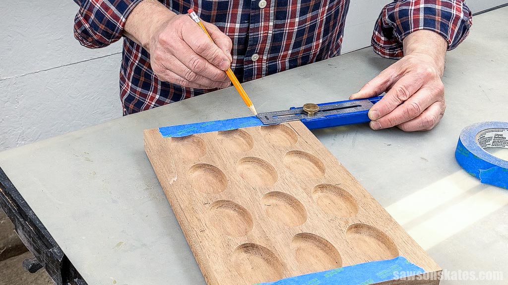 Using a pencil to mark the recessed handle area in a handmade deviled egg serving tray