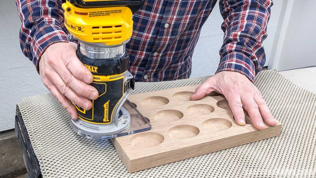 Using a router and a roundover bit to smooth a handmade deviled egg holder's edges