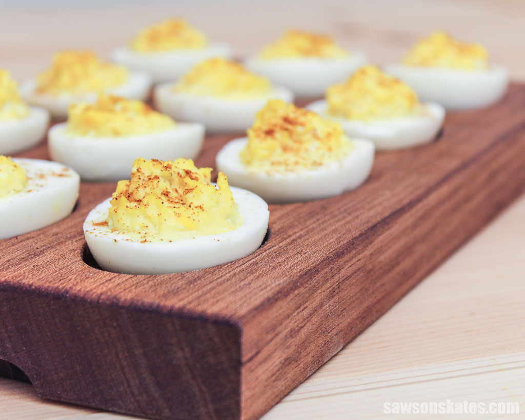 Closeup of deviled eggs in a handmade wooden serving platter