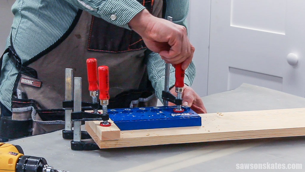 Clamping a shelf pin jig to a wall-mounted DIY spice cabinet's side