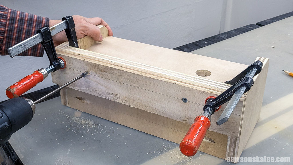 Attaching the French cleat to the back of a DIY jigsaw holder using wood screws