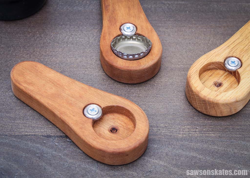Three wooden handmade bottle openers