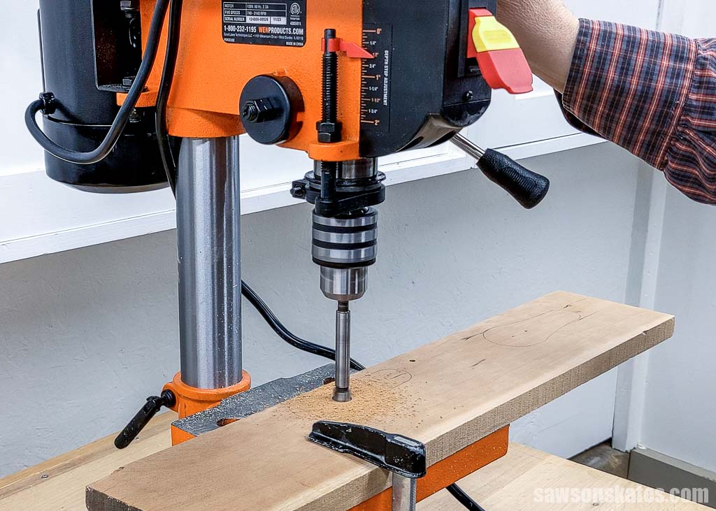 Using a drill press to make a hole for a washer in a DIY bottle opener