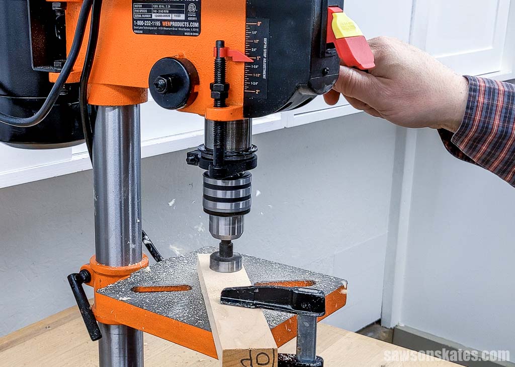 Using a drill press to make a test hole in a workpiece