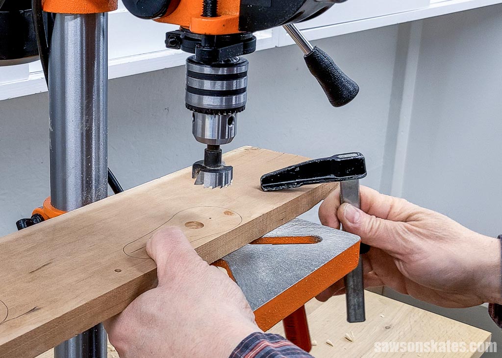 Securing a workpiece to a drill press table using a clamp
