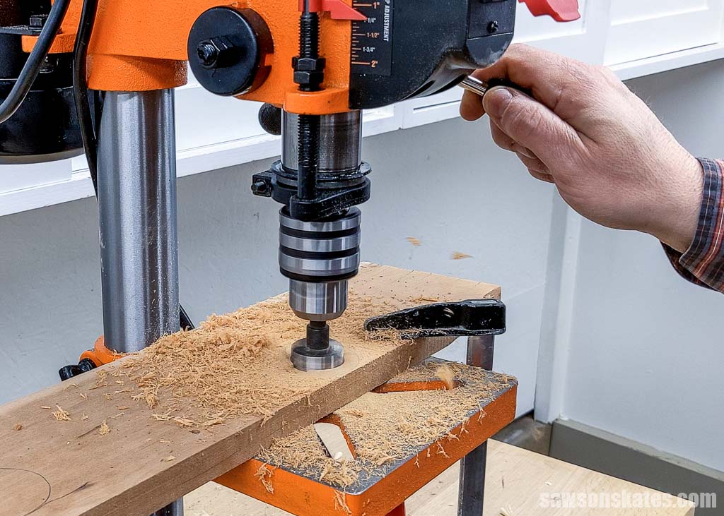 Using a drill press to make a hole for a cap recess in a homemade bottle opener