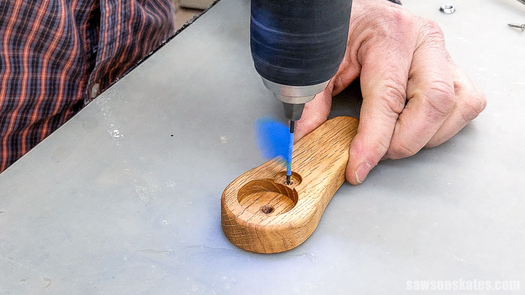 Drilling a pilot hole in a handmade bottle for a screw