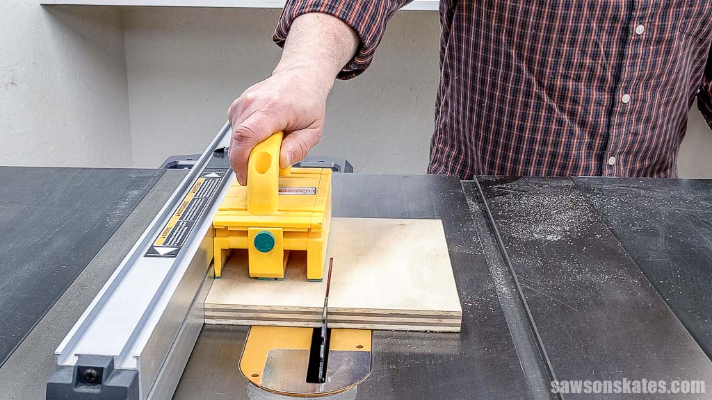 Ripping a piece of plywood to width using a table saw