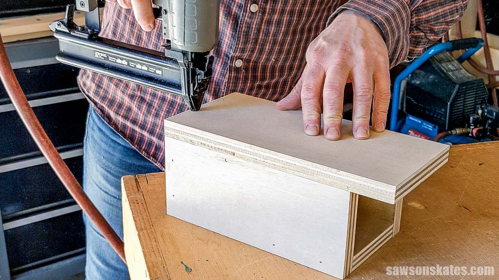 Using a brad nailer to attach the back