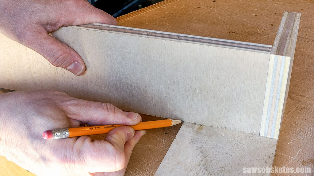 Marking the length for a DIY French cleat measuring tape holder's shelves