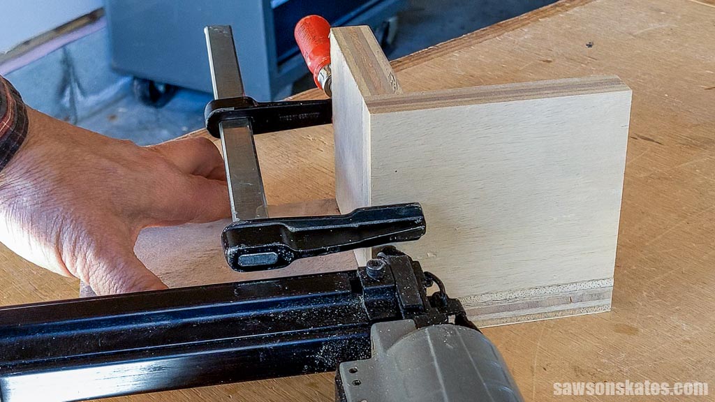 Attaching a DIY French cleat measuring tape holder's middle shelf with brad nails