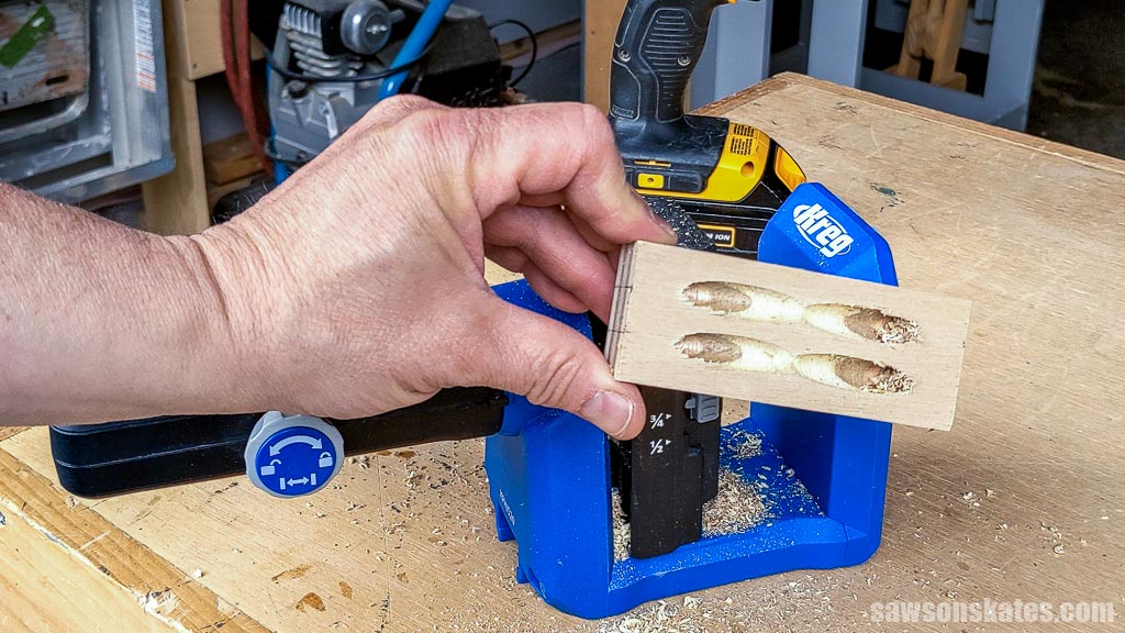 Hand holding a cleat with four pocket holes