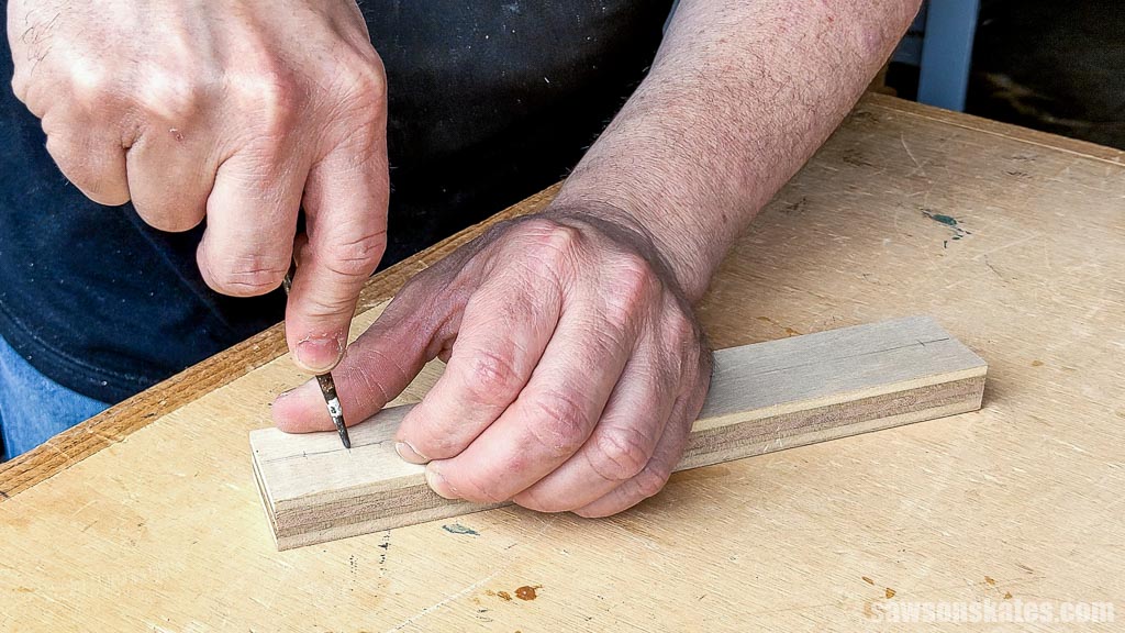 Using an awl to make a starting point for the drill bit