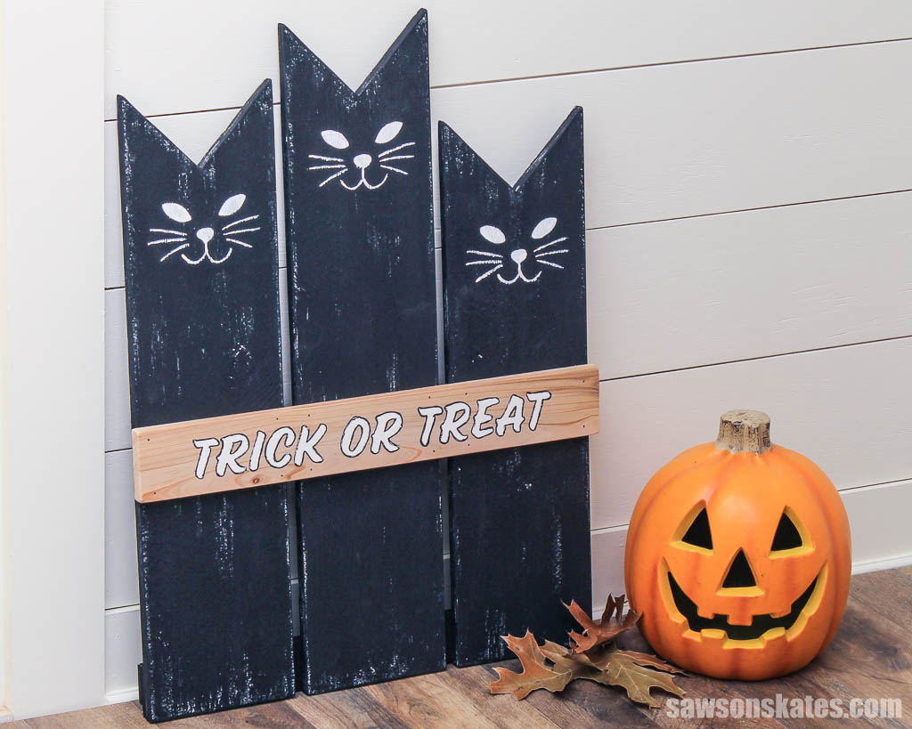DIY Halloween cat sign leaning against a wall