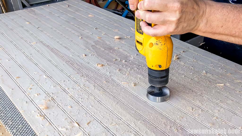 Drilling a hole in the back panel with with a Forstner bit