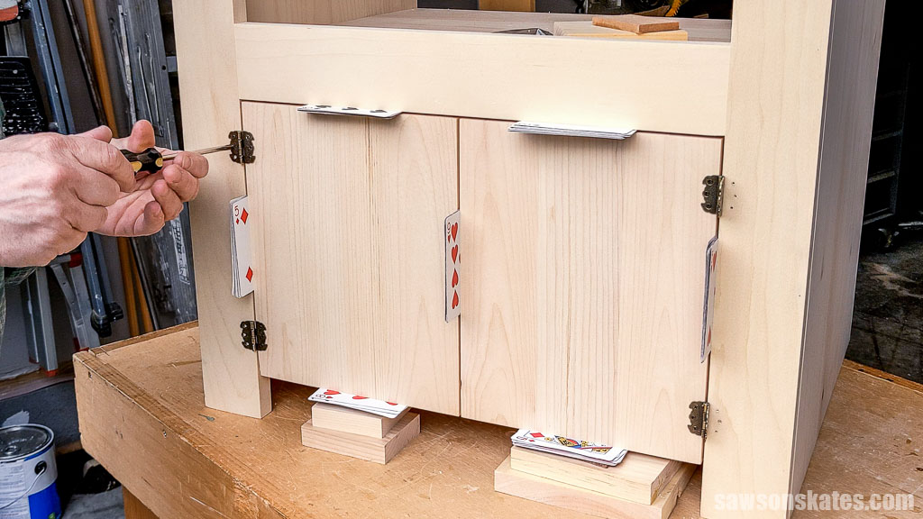 Attaching the door hinges to the face frame with screws
