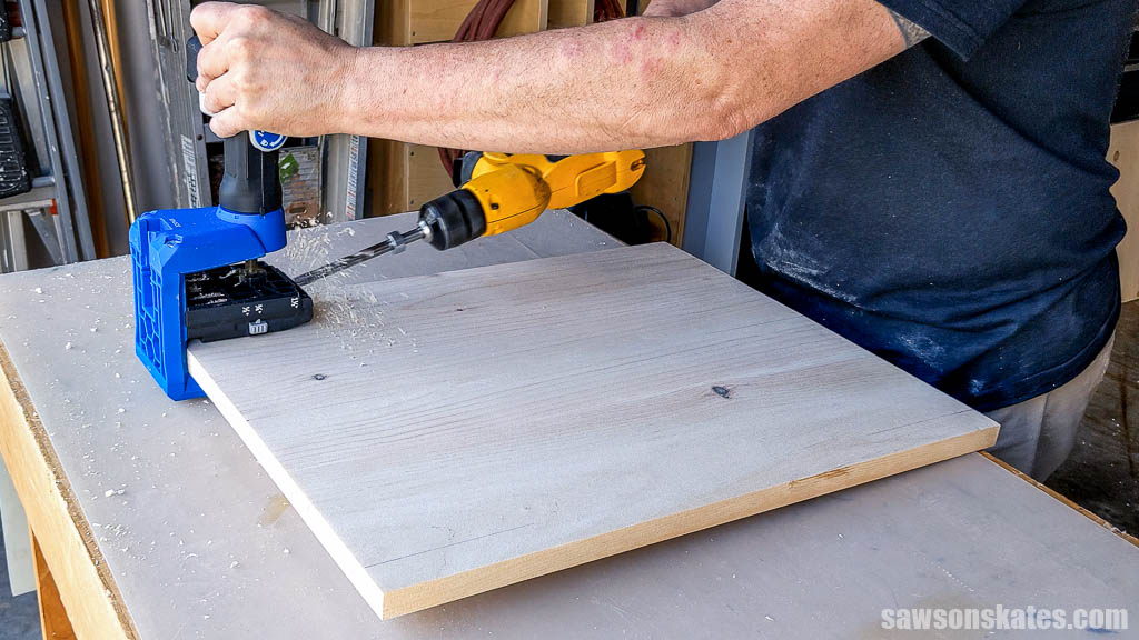 Using a pocket hole jig to drill pocket holes in a shelf