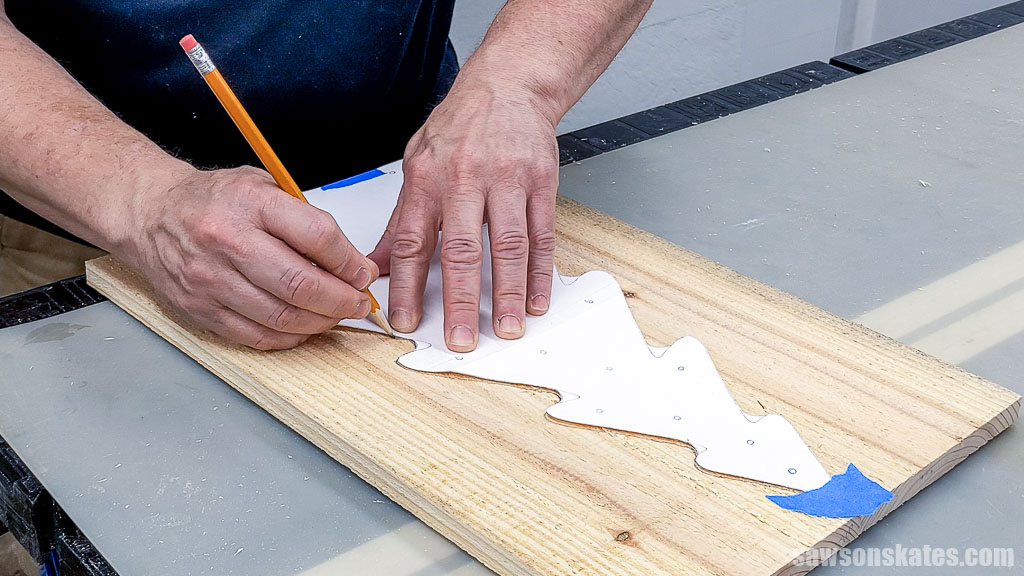 Tracing a Christmas tree pattern onto a board