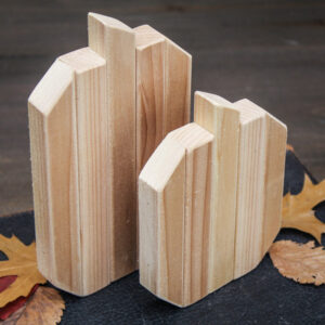 Two cedar scrap wood pumpkins on a table