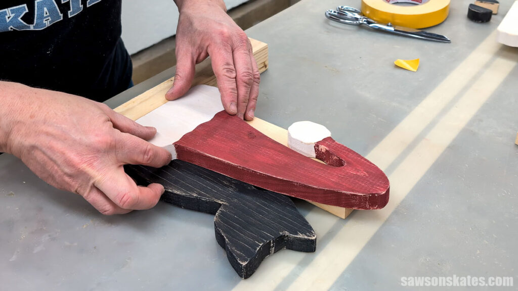 Positioning the hat on the cat