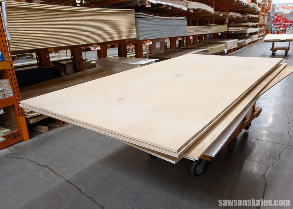 Plywood on a cart in a store aisle