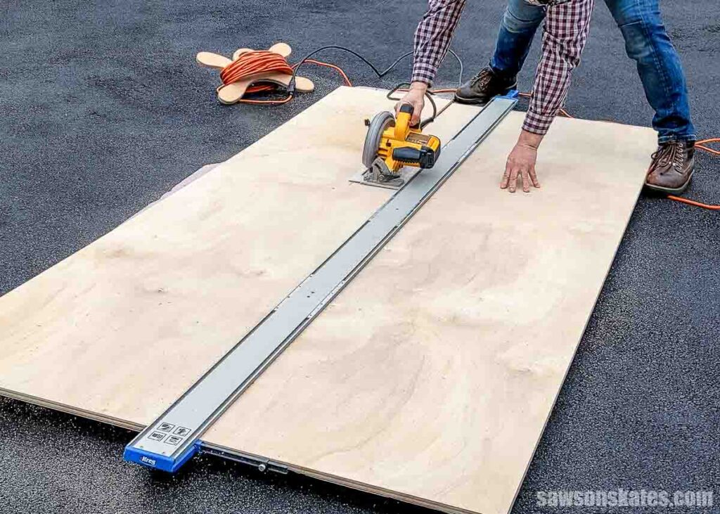 Scott cutting plywood in a driveway