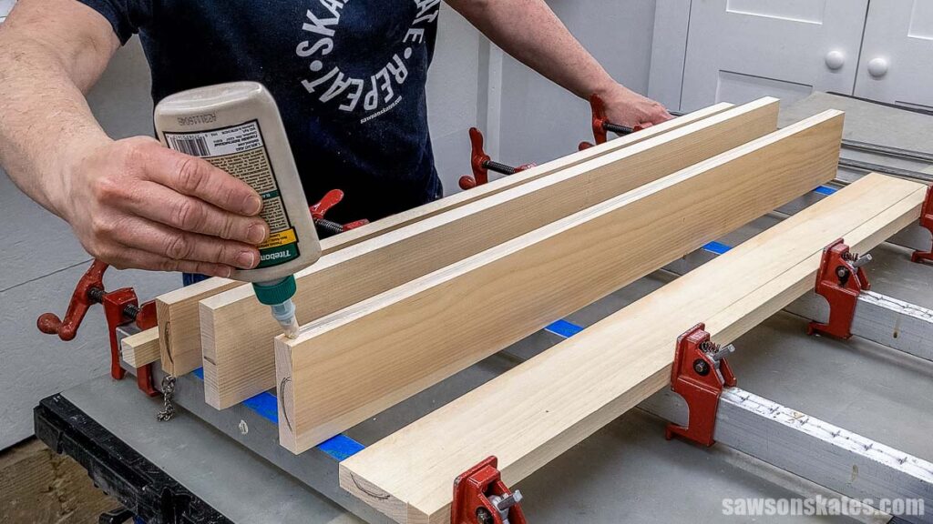 Scott applying glue to the edge of a board
