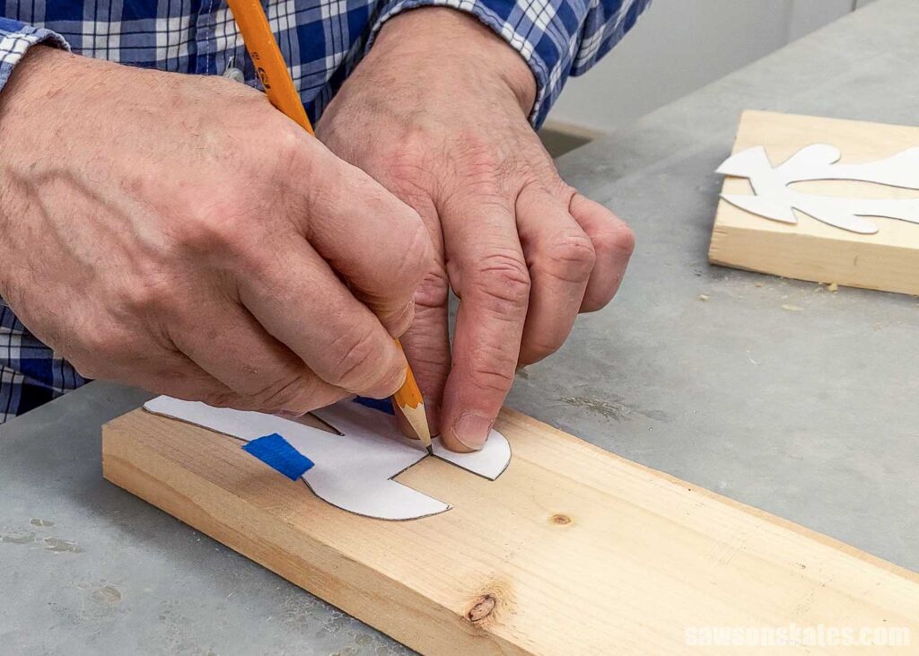 Scott tracing the reindeer leg template onto a board