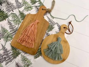 yarn tassel tree on wooden cutting boards