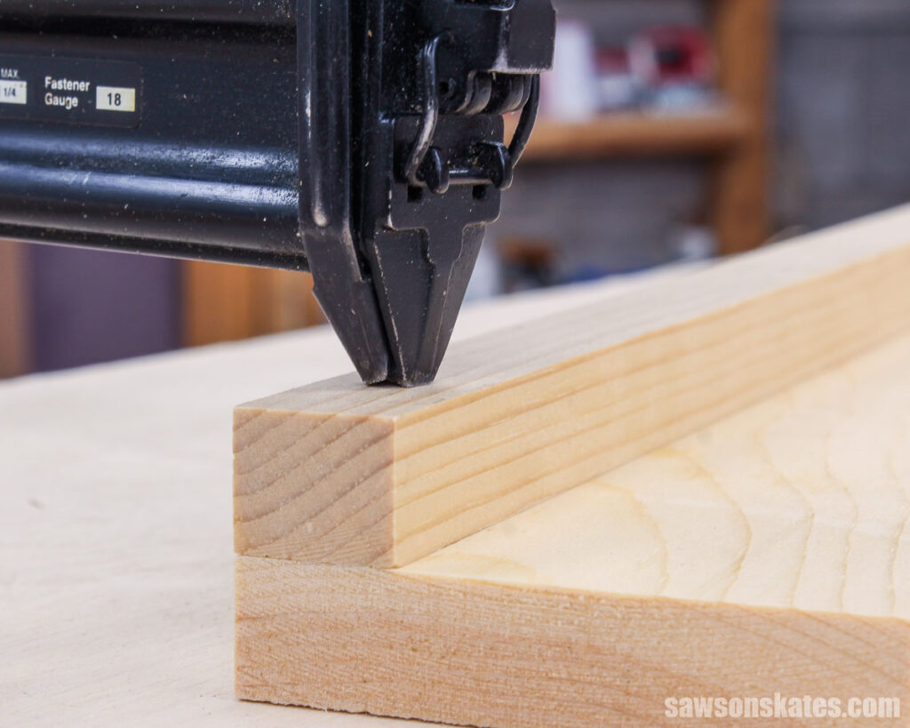 Closeup of attaching a narrow workpiece to a board using a brad nailer