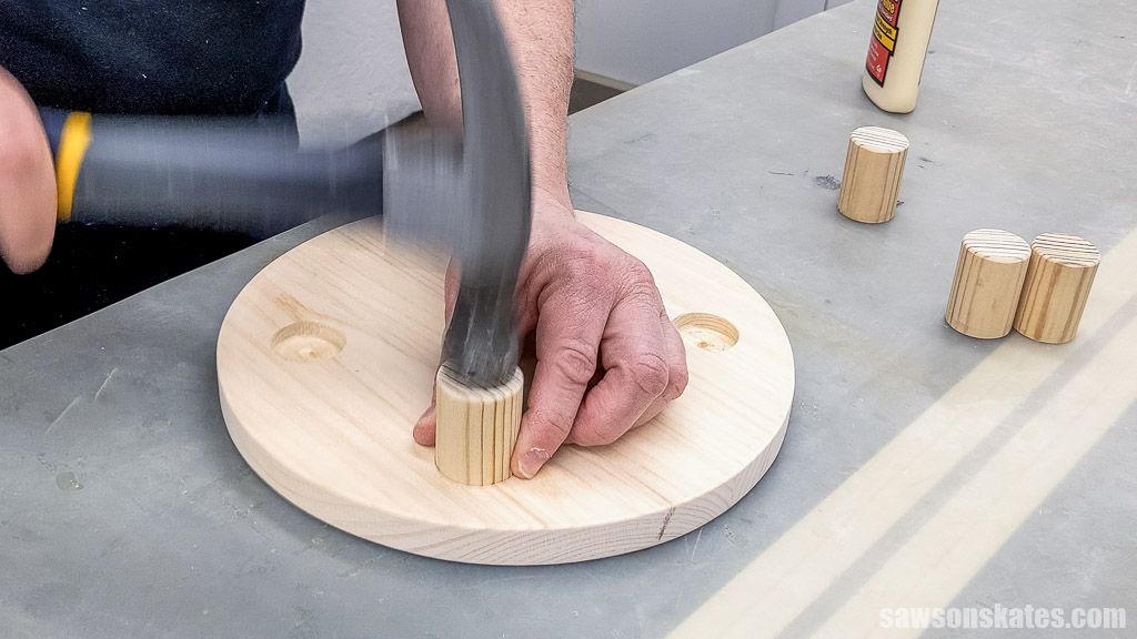 Inserting the dowel in the hole using a hammer