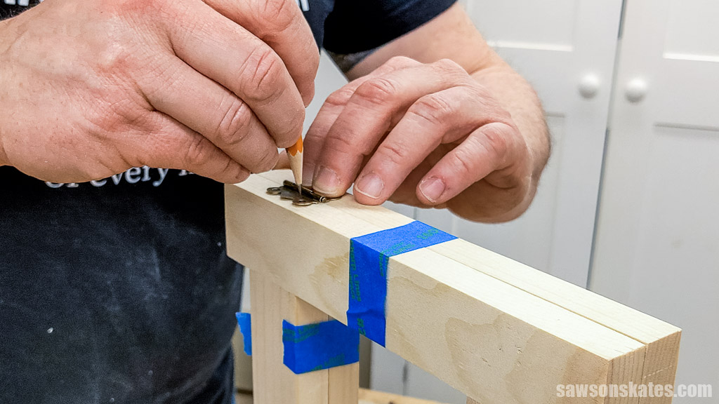Tracing the hinges holes onto the frame with a pencil