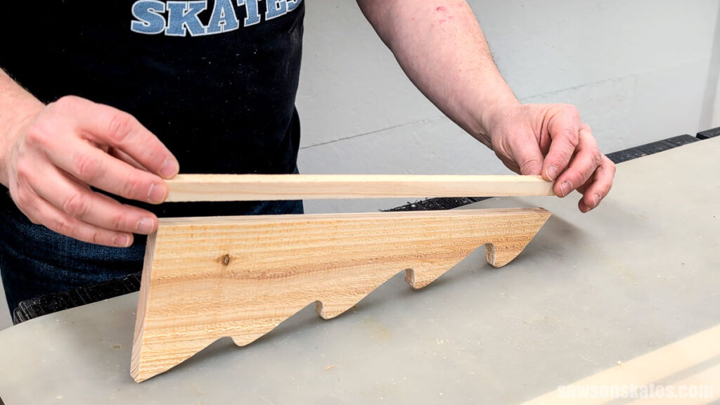 Positioning a narrow piece of wood on a tree cut out