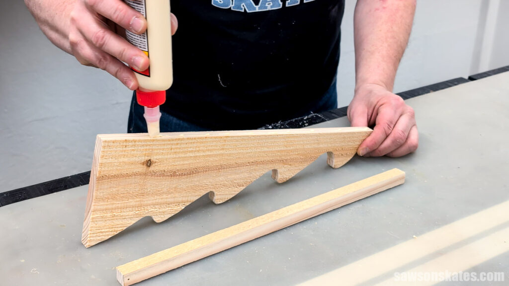 Applying glue to the edge of a Christmas Tree cutout