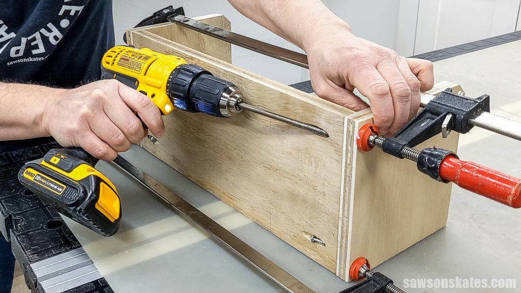 Driving a pocket hole screw with a drill to attach the back to the side