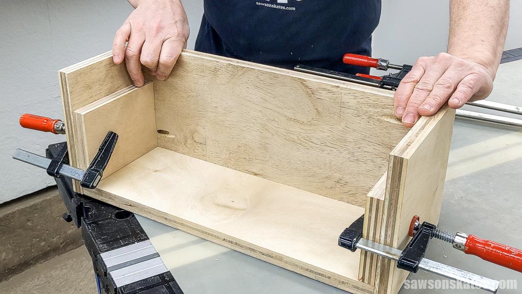 Hands sliding the shelf into position