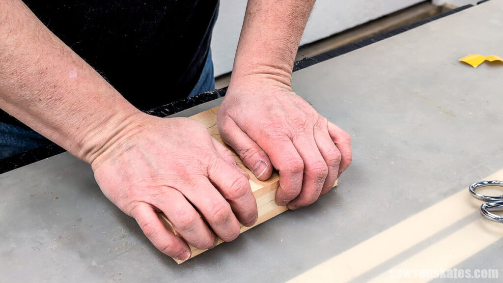 Hands pressing two boards together
