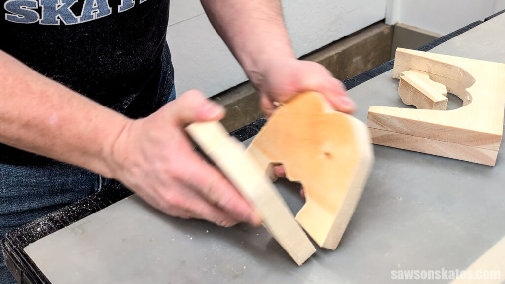 Hands separating two wood cutouts
