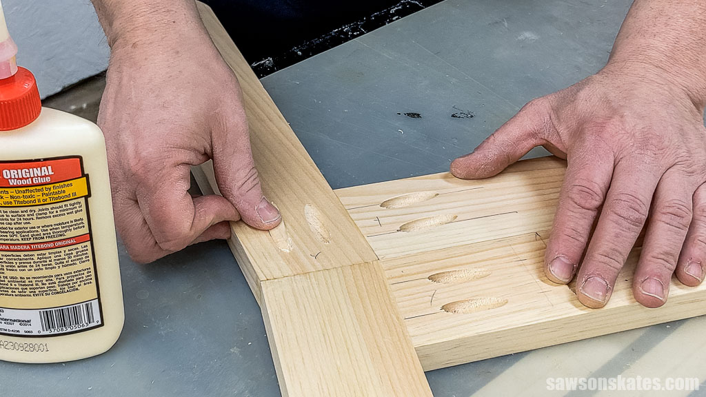 Fingers inserting a plug into a pocket hole