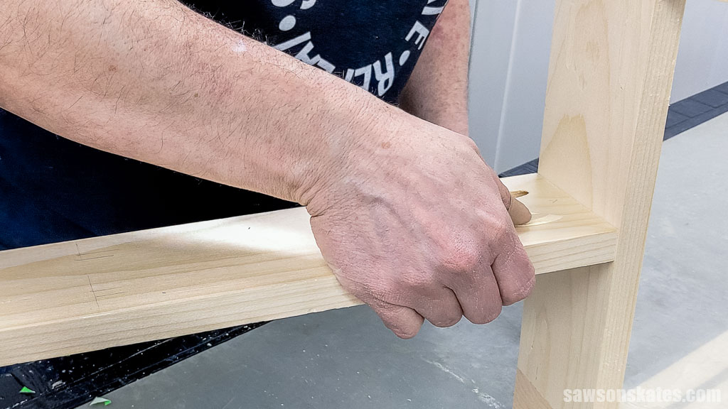 Inserting a pocket hole plug into a table's stretcher