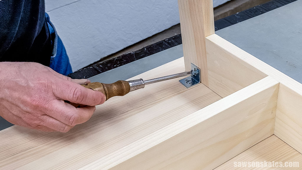 Attaching and expansion bracket to table leg using a screwdriver