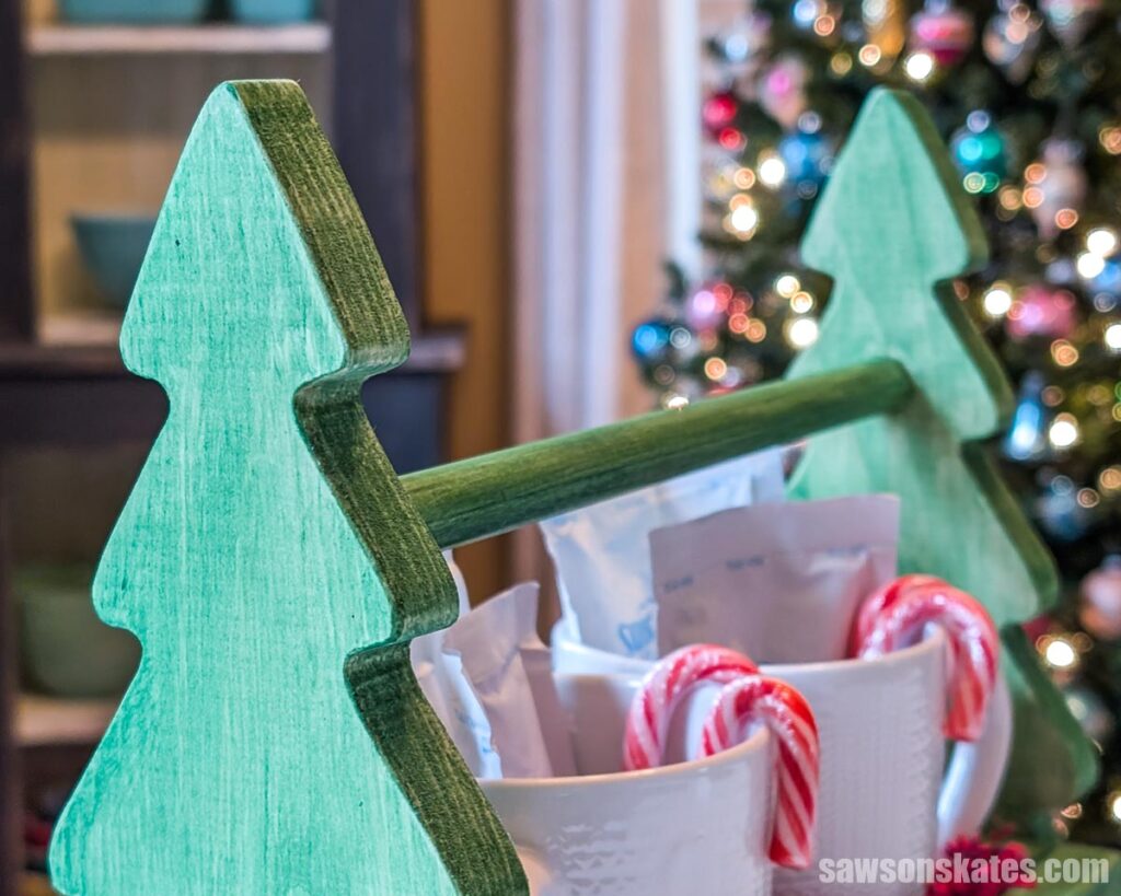 Close of the hot chocolate caddy's Christmas tree-shaped handle area