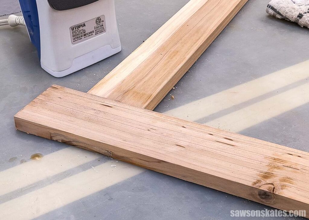 Board with the stained removed with clothes iron in the background