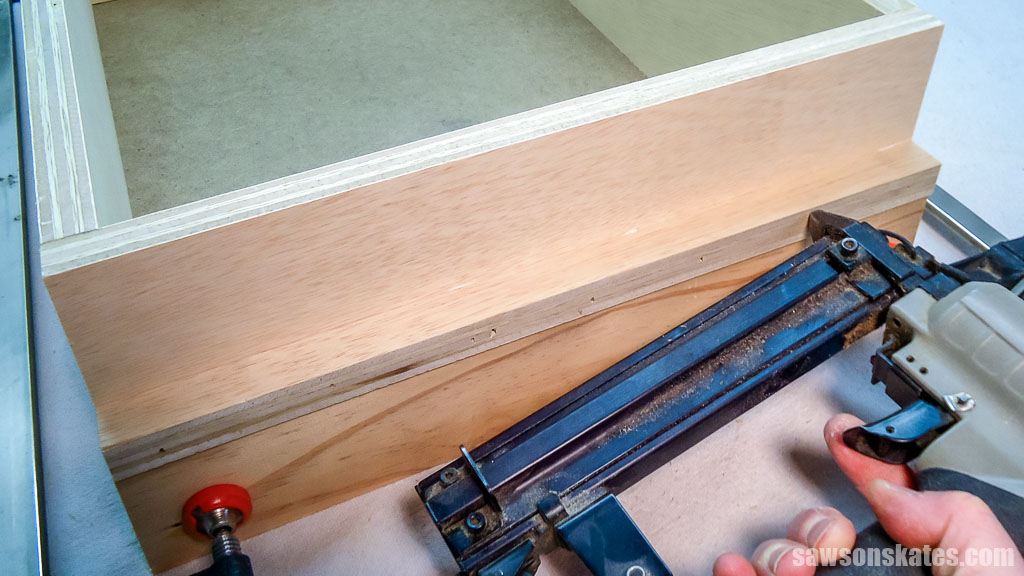 Using a brad nailer to attach the drawer slide