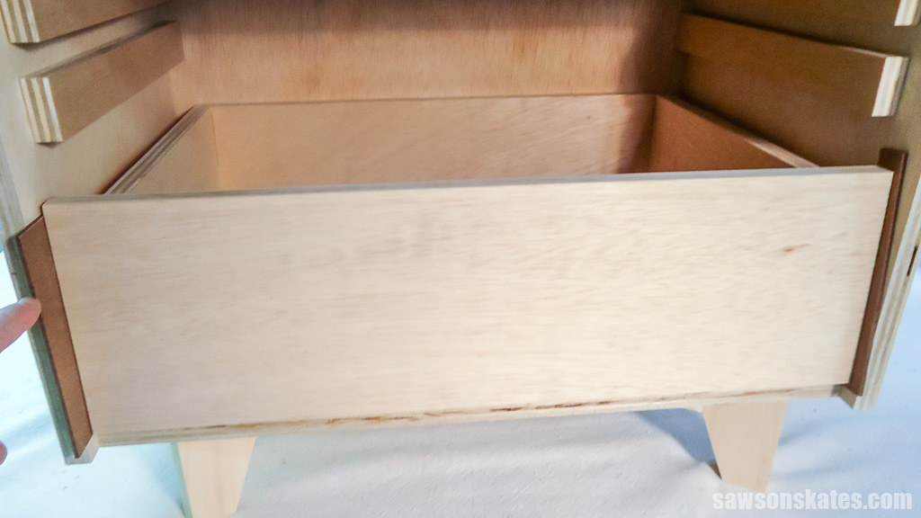Placing spacers on either side of the drawer front