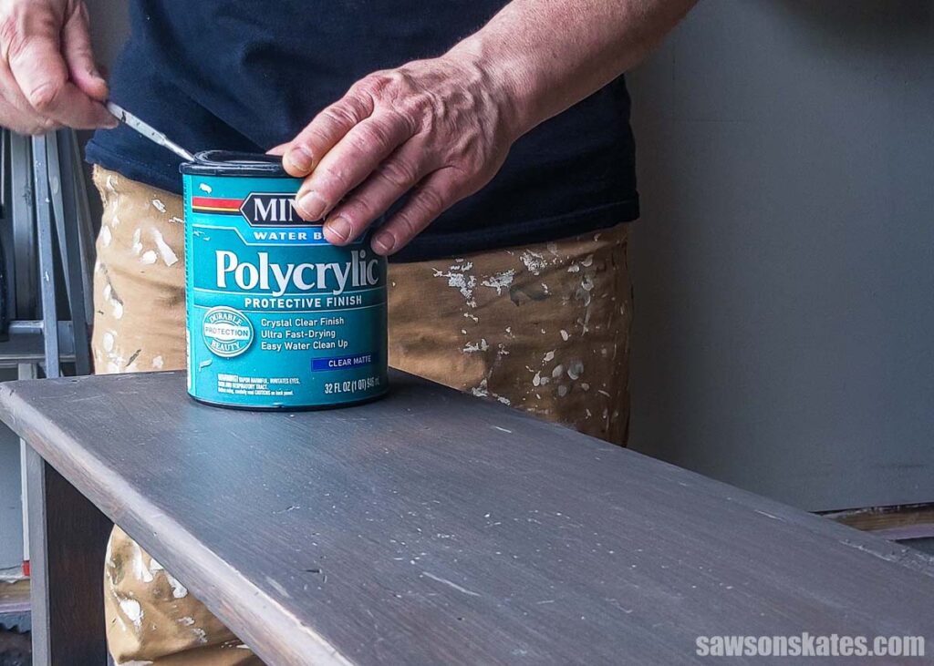 Hands opening a can of Poylycrylic